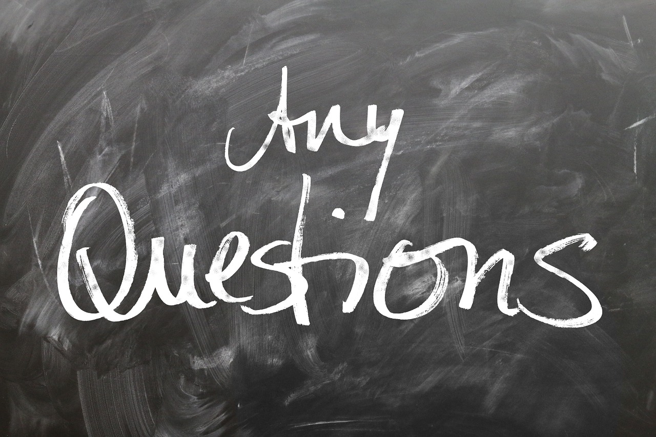 "Any questions?" written on a chalkboard